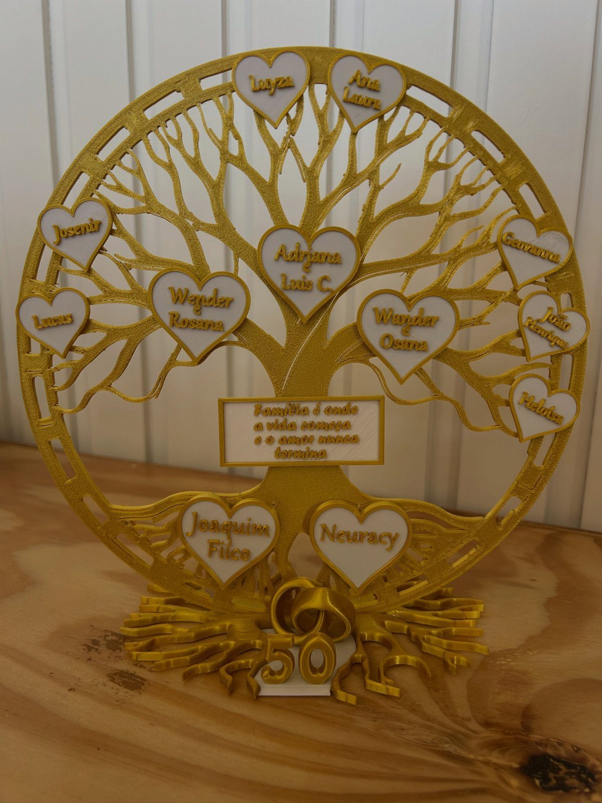 Gold circular family tree sculpture with heart-shaped name plaques and number 50 base.