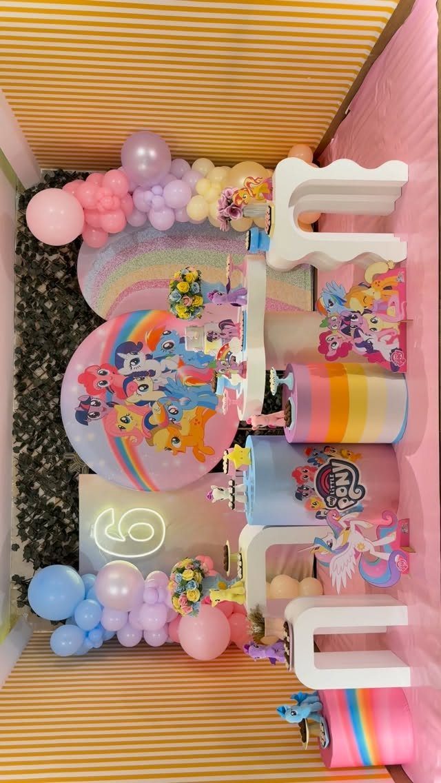 My Little Pony party decorations with colorful balloons and character-themed graphics.