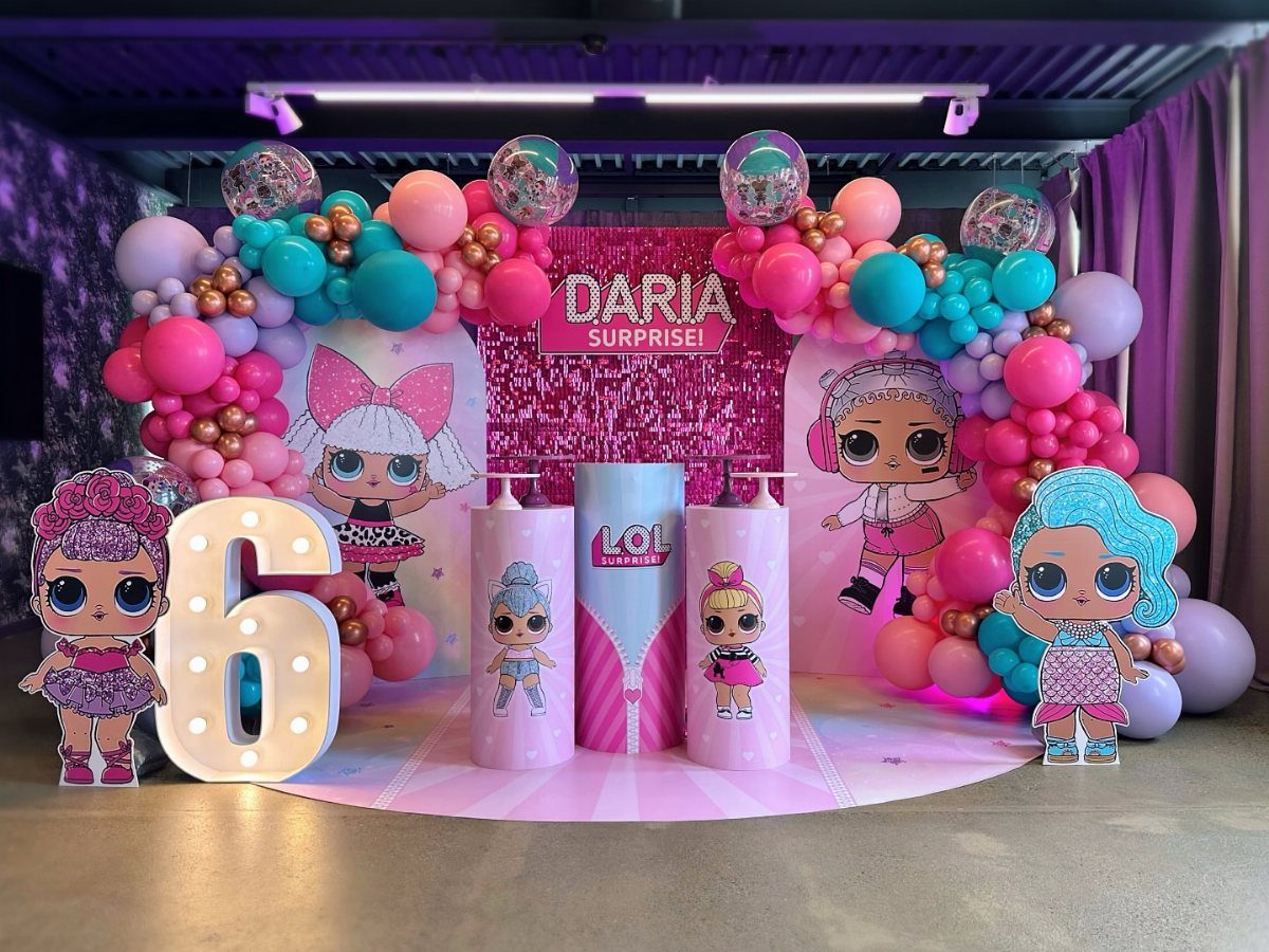 LOL Surprise party decoration with pink balloons, doll cutouts, and a glowing number 6.