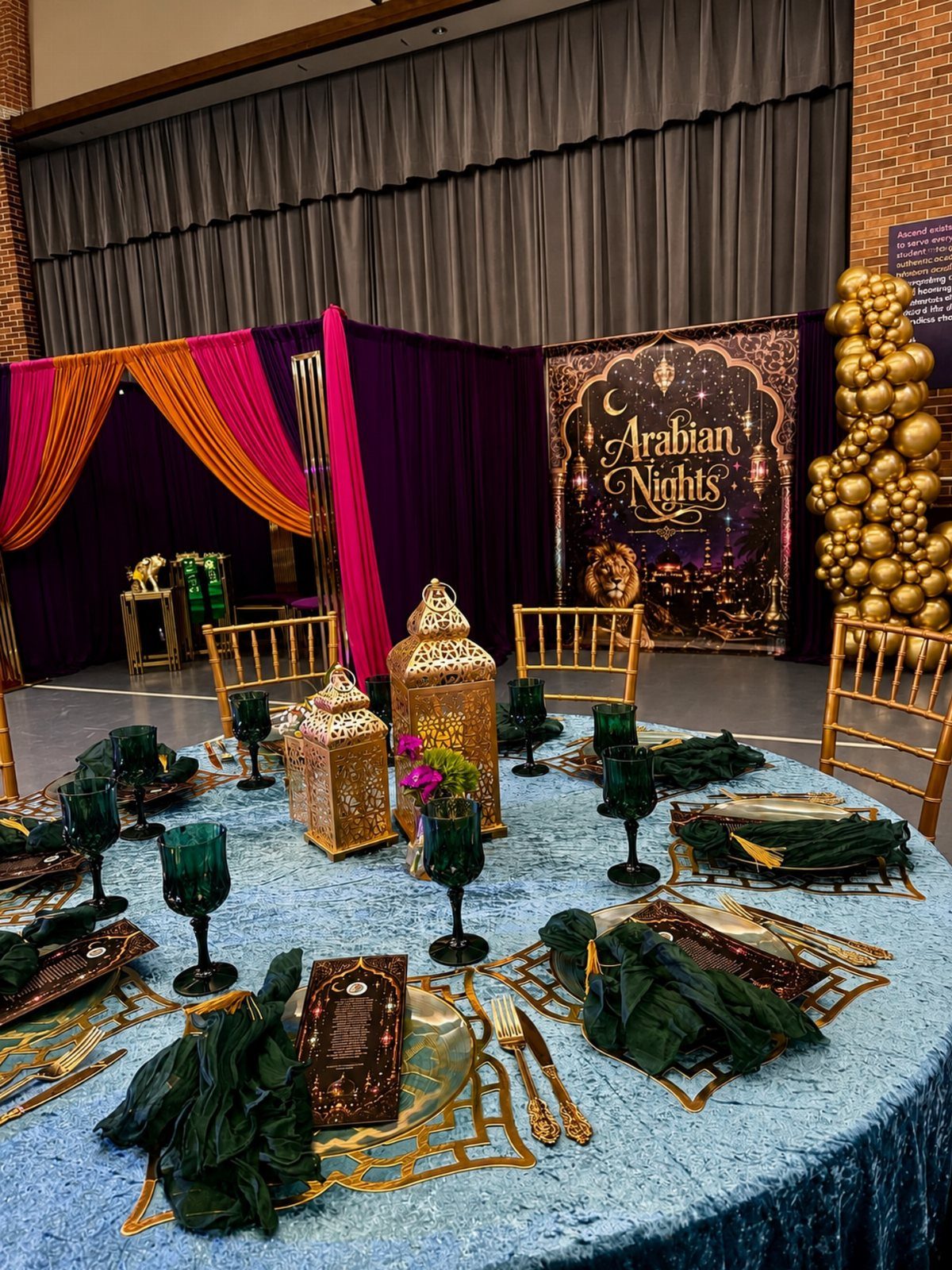 Arabian Nights themed event setup with a photo backdrop and decorated table.