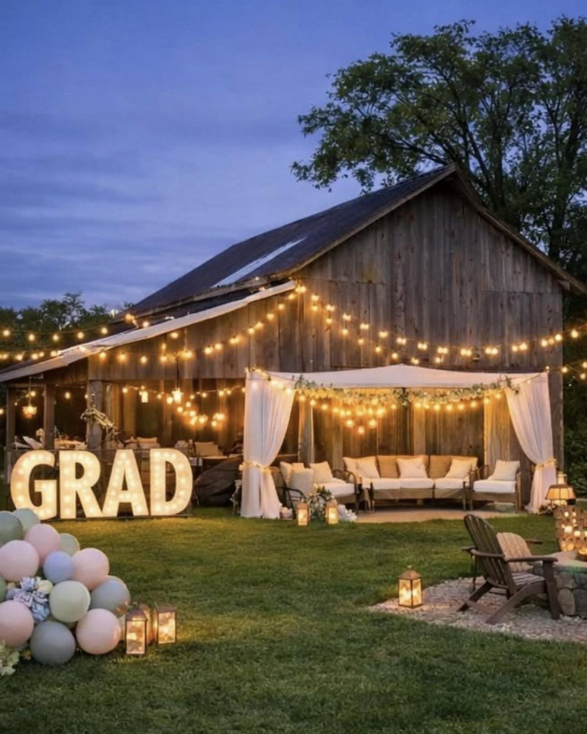 Outdoor graduation party setup with string lights, illuminated GRAD letters, and a lounge area.