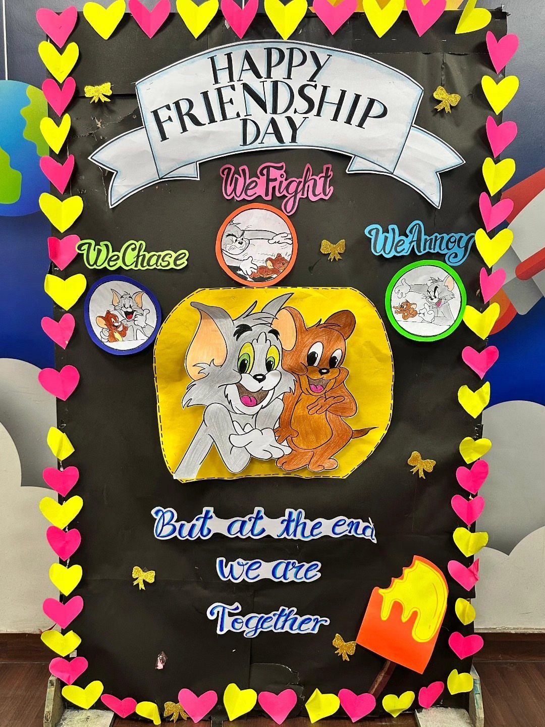 Friendship Day bulletin board with Tom and Jerry characters and colorful paper hearts.