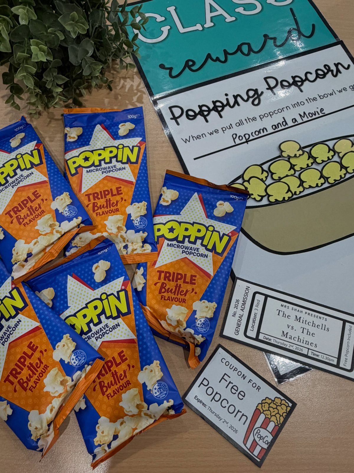 Microwave popcorn bags and reward signs for a classroom movie and popcorn party.