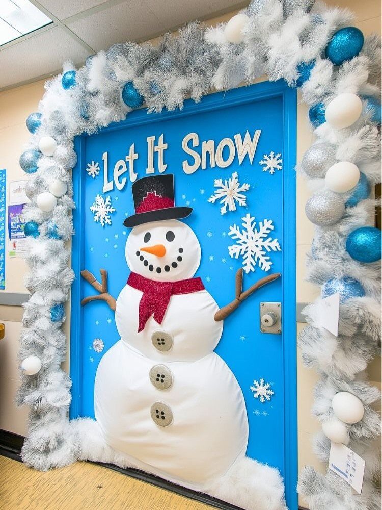 Blue classroom door decorated with a large fabric snowman and winter tinsel garland.