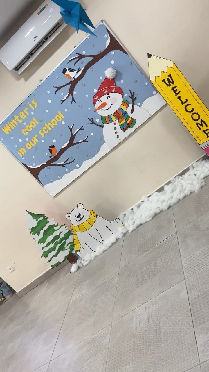 Winter themed classroom wall display with a snowman, polar bear, and festive text.