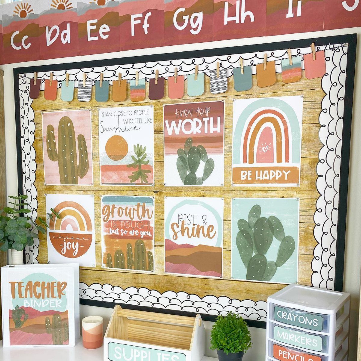 Bohemian themed classroom bulletin board with cactus and rainbow posters in earthy tones.