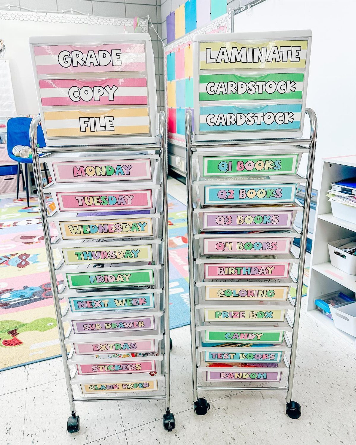 Two silver rolling carts with pastel colored labels for classroom organization.