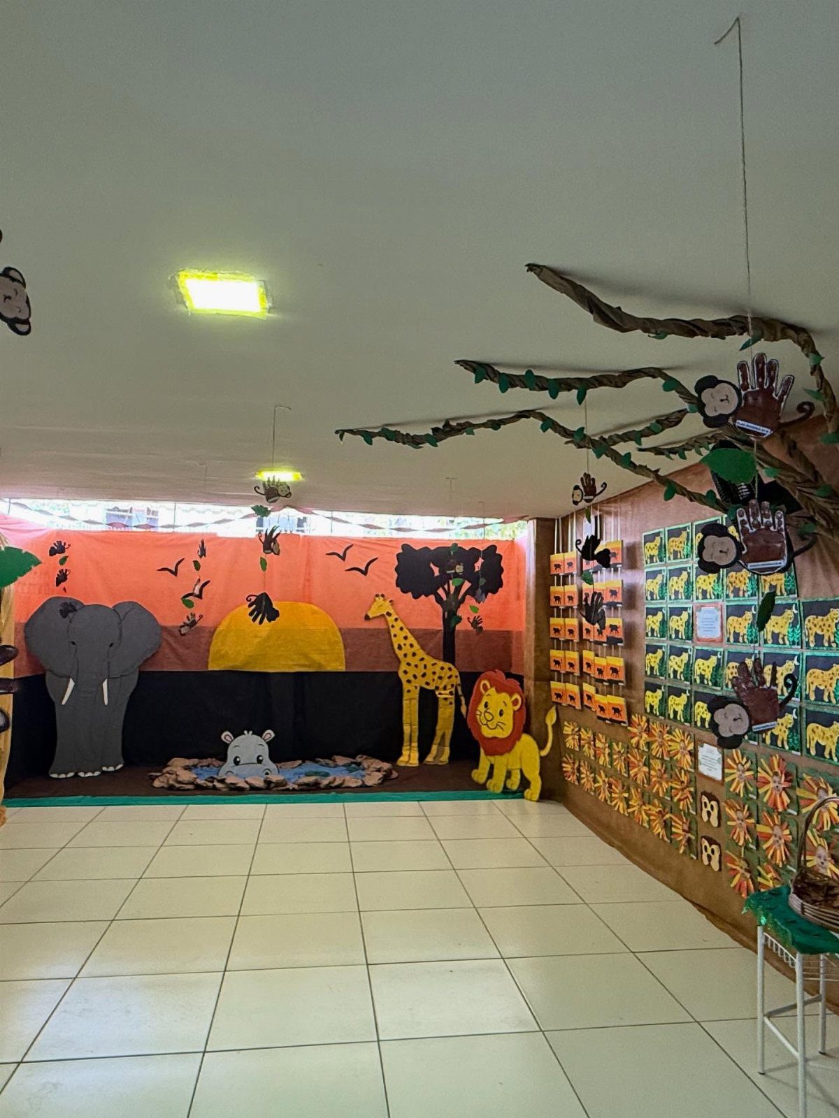 Safari themed classroom with large animal cutouts and a nature backdrop.