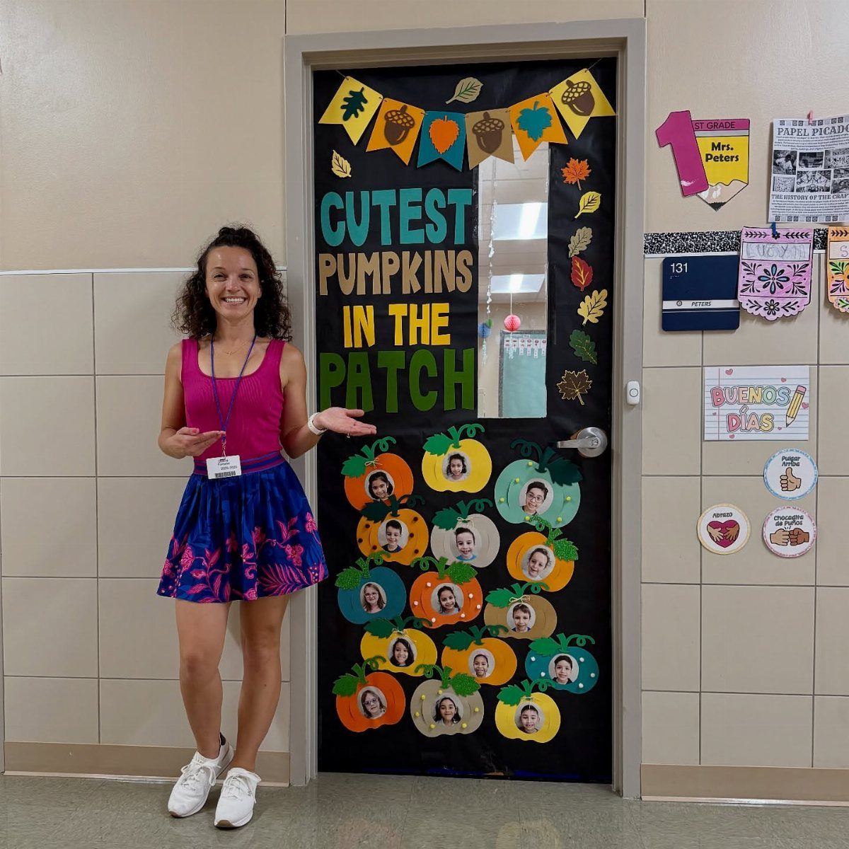 Classroom door decorated as a pumpkin patch with student photos and autumn bunting.