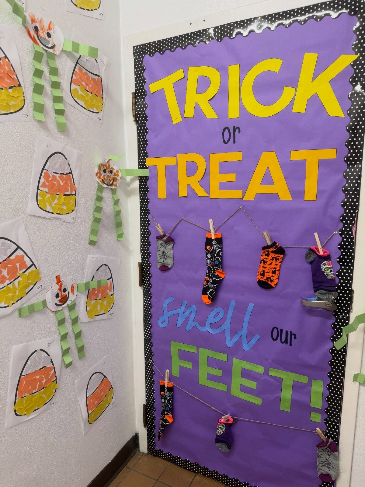 Purple classroom door decorated with Halloween socks and Trick or Treat text.
