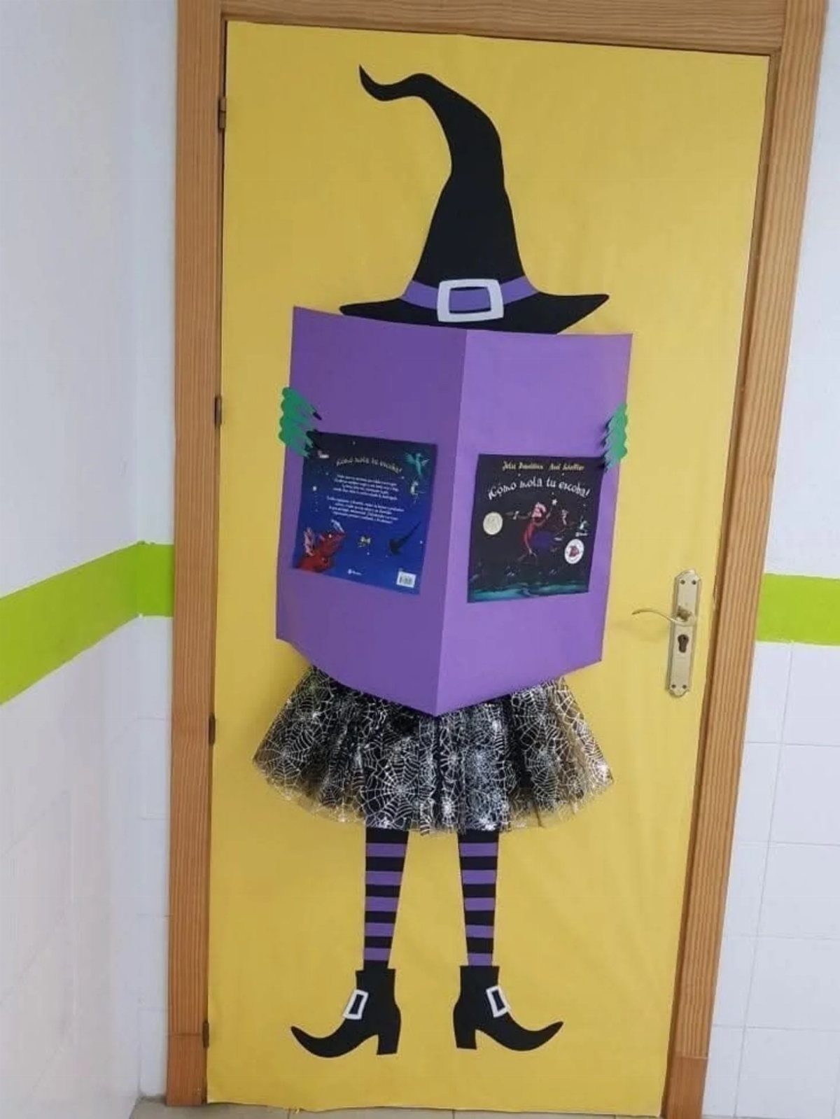 Witch-themed classroom door decoration with a purple body and sparkly black tutu.