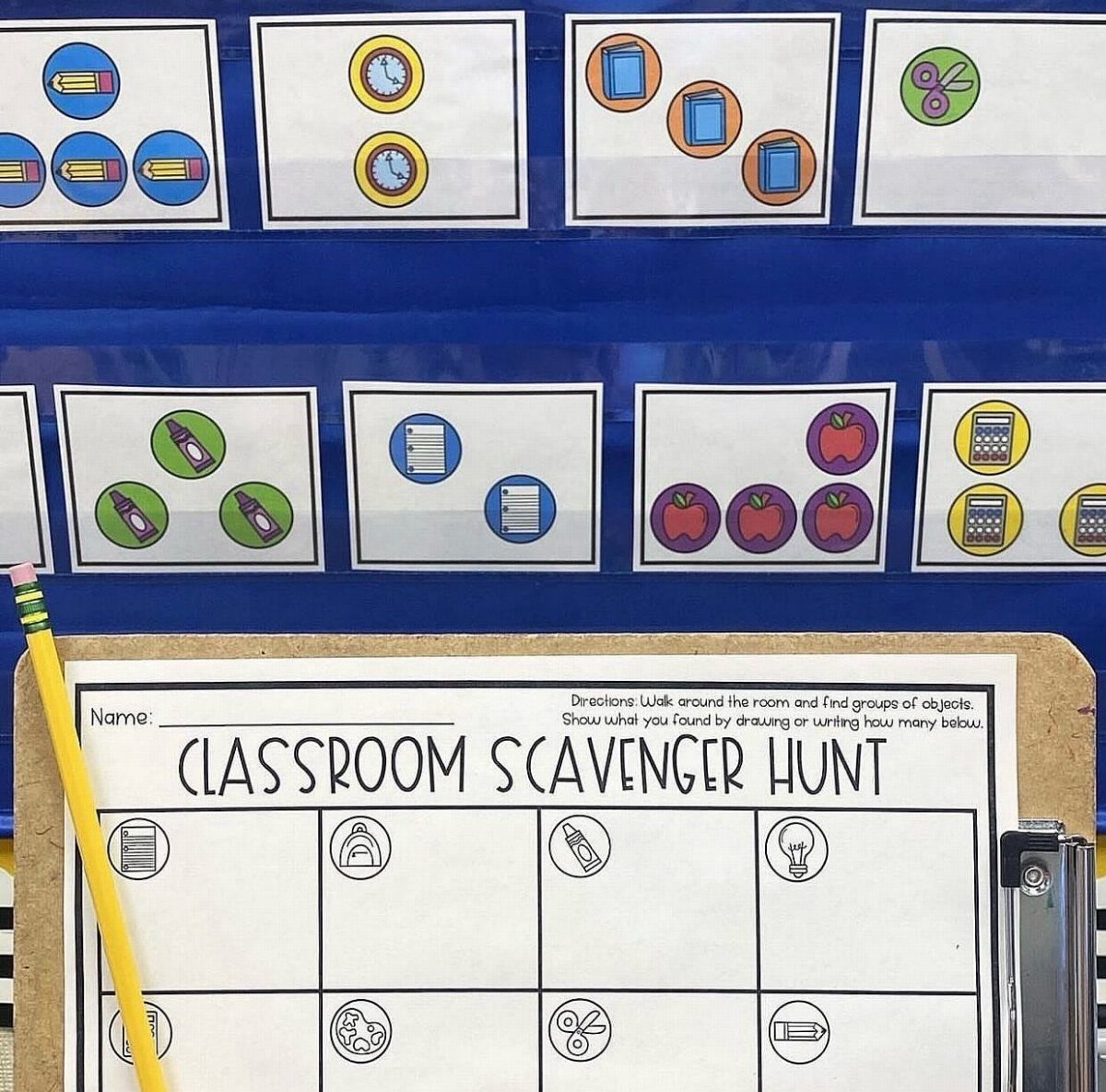 Classroom scavenger hunt worksheet on a clipboard with illustrated clue cards in background