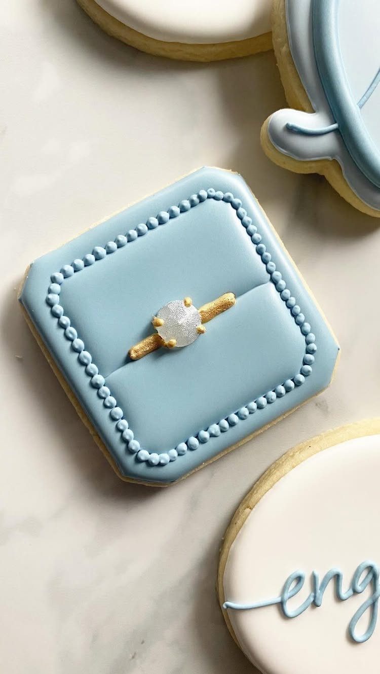 Light blue ring box cookie with a sparkling edible glitter diamond ring center.