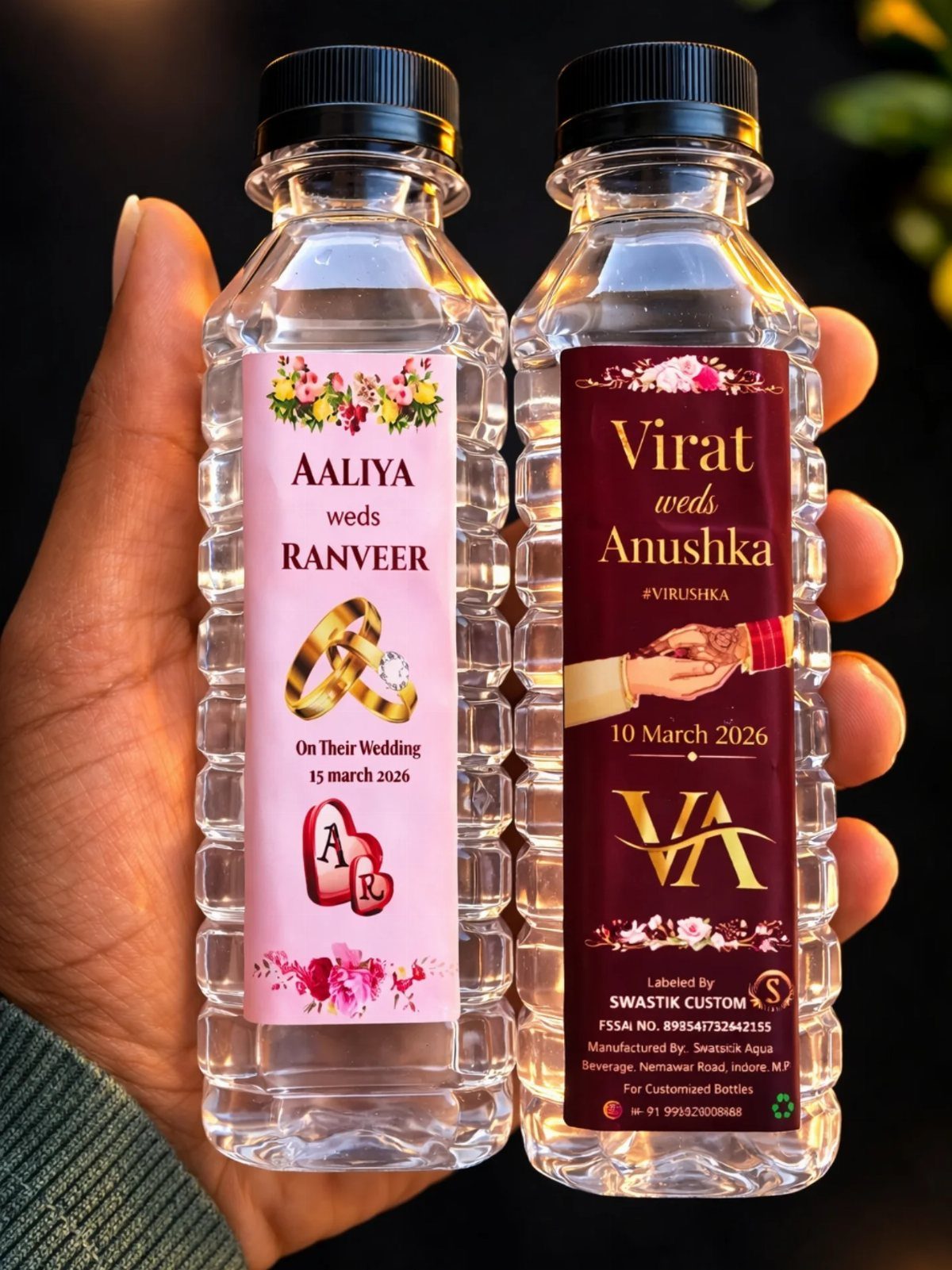 Two clear plastic water bottles with personalized wedding labels held in a hand.