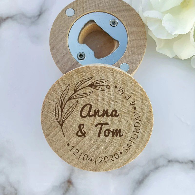 Two circular wooden bottle openers, one engraved with names and a wedding date.