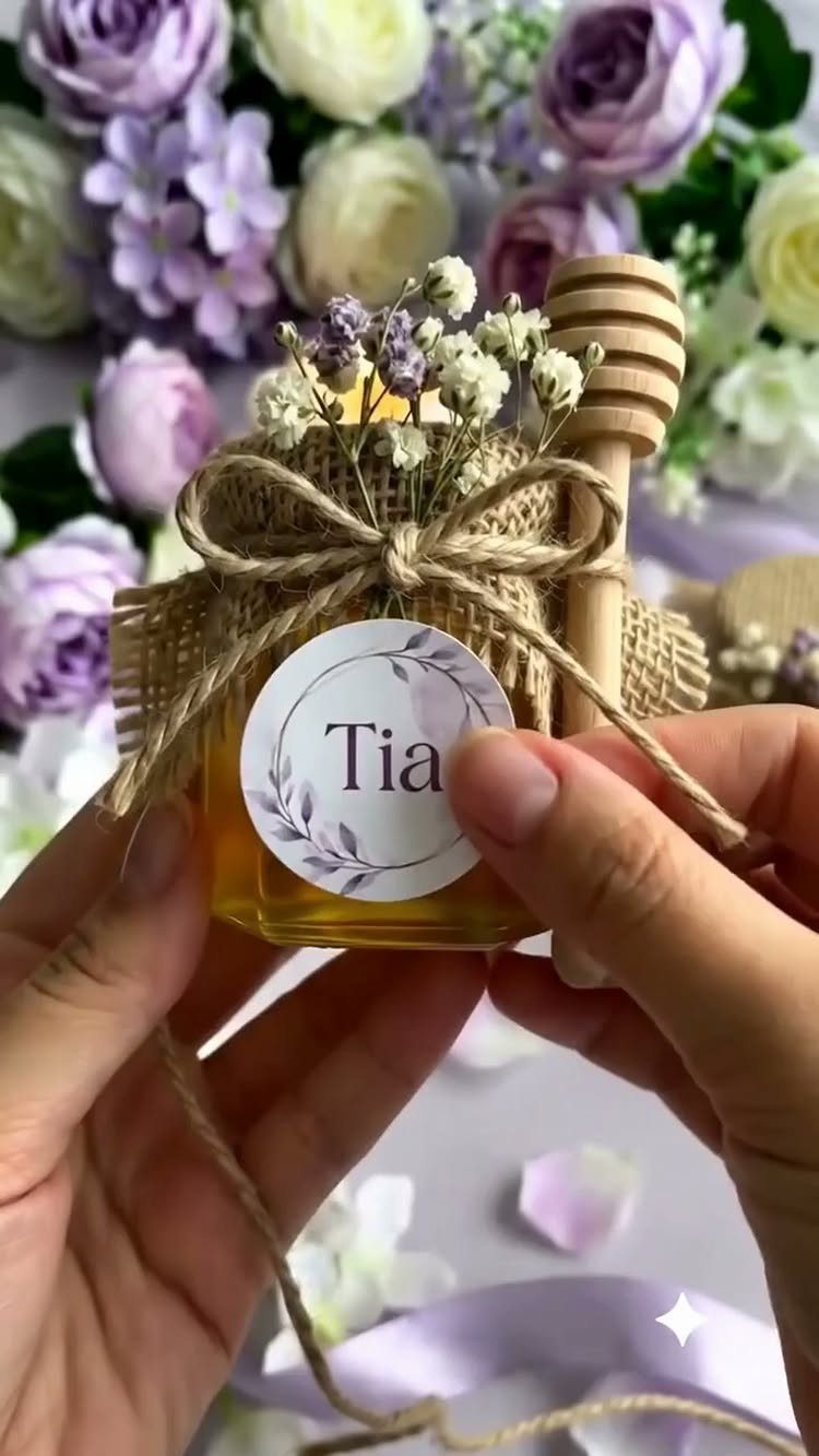 Small honey jar with a personalized name tag, burlap bow, and floral background.