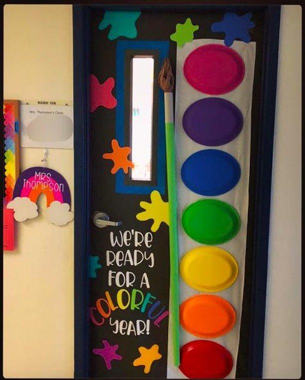 Classroom door decorated as a paint palette with colorful plates and a paintbrush.