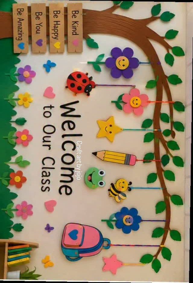 Classroom door decorated with a tree, colorful paper cutouts, and a welcome message.