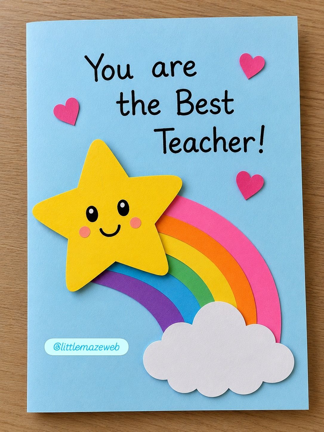 Handmade blue teacher card with a smiling yellow star and colorful rainbow.