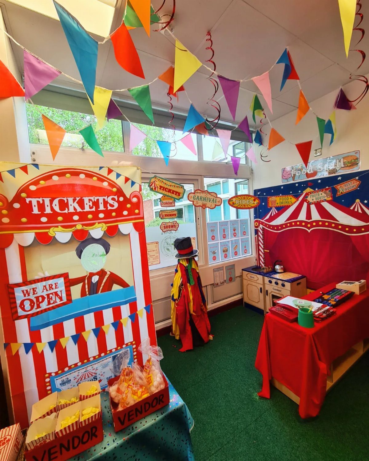 Circus themed classroom with colorful bunting, ticket booth, and red tent backdrop.