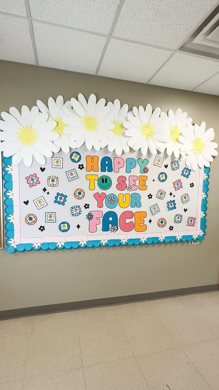 Classroom bulletin board with large white daisies and colorful welcome text.