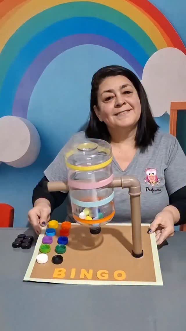 Woman presenting a homemade Bingo game made from a plastic bottle and colorful caps.