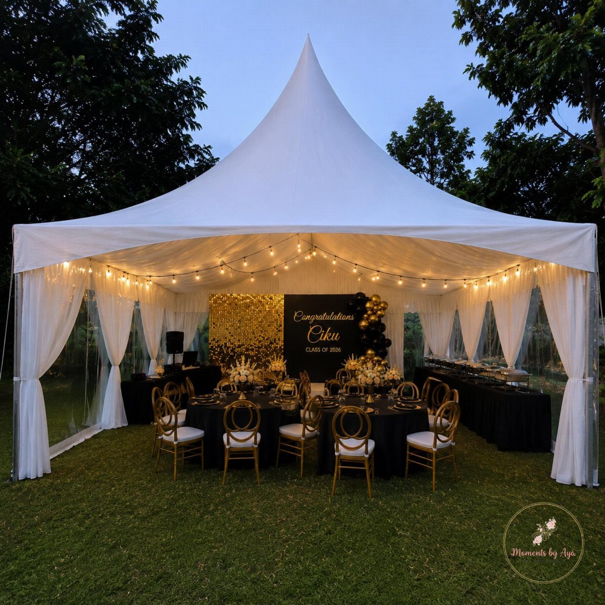 Graduation party setup inside a white tent with gold and black decorations.