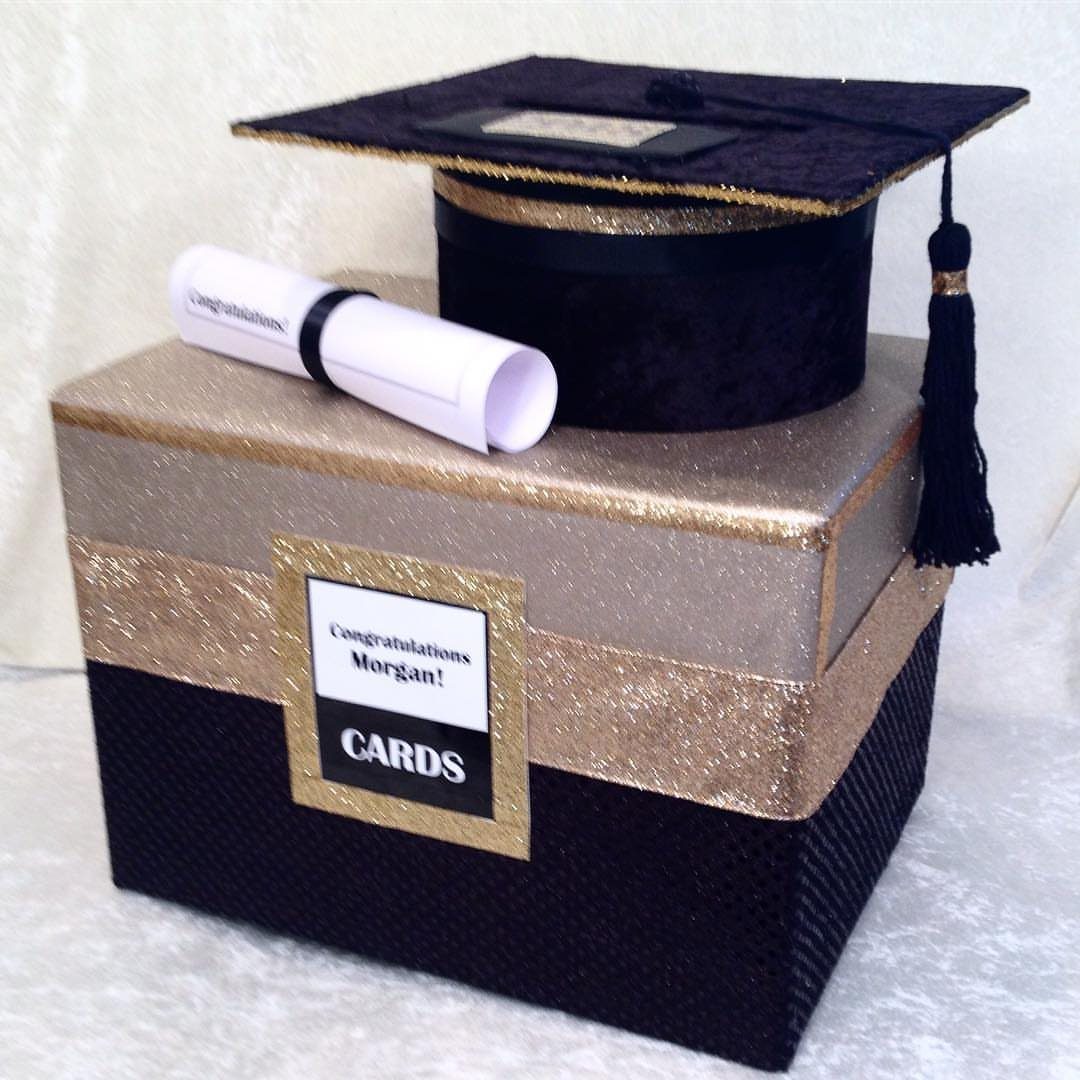Graduation card box decorated in black and gold with a cap and diploma.
