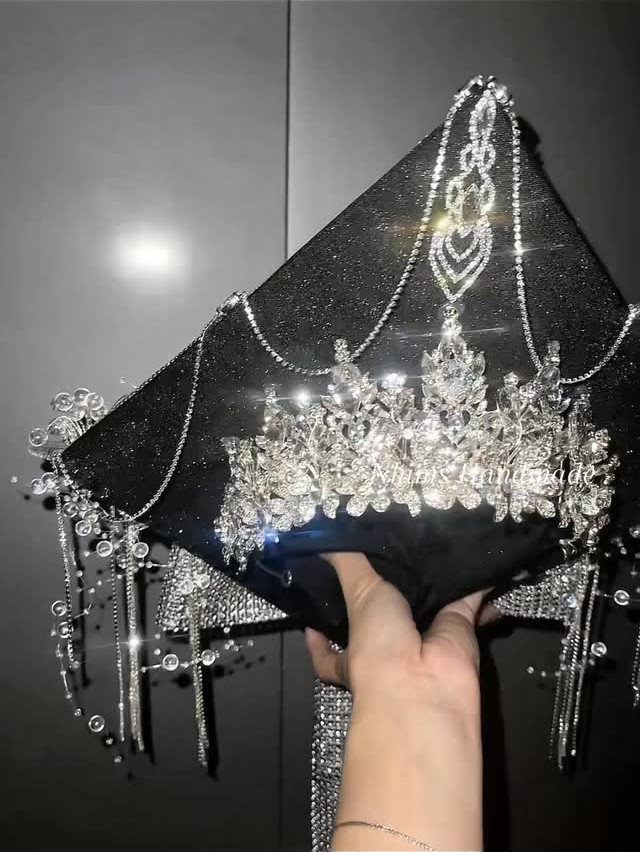 Graduation cap decorated with a sparkling rhinestone crown and dangling silver crystal chains.