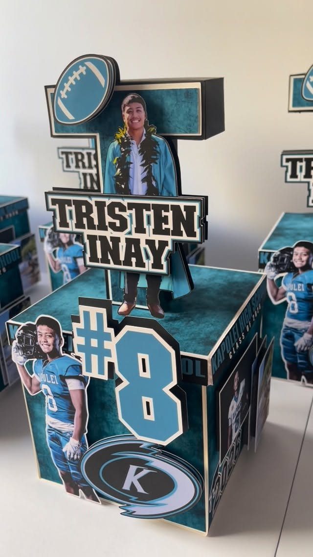Blue and black football themed graduation centerpiece with player cutouts and name