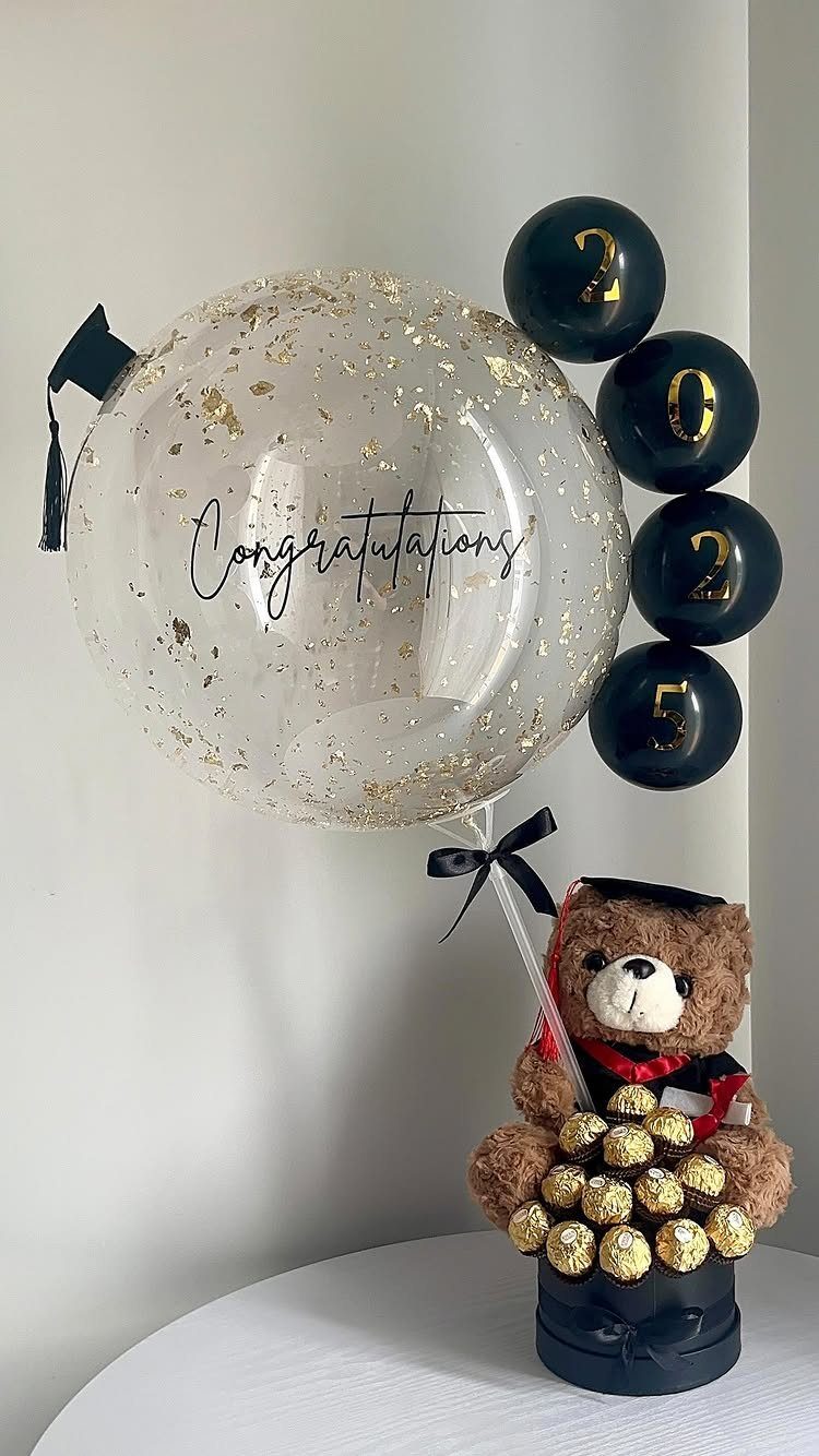 Graduation centerpiece with a congratulations balloon, 2025 balloons, and a teddy bear.
