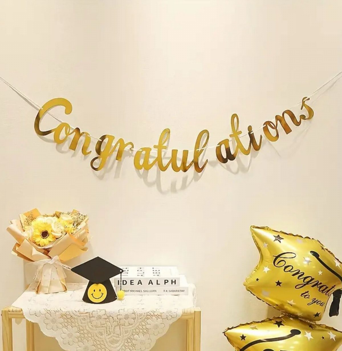 Gold Congratulations banner and graduation decorations with yellow flowers and star balloons