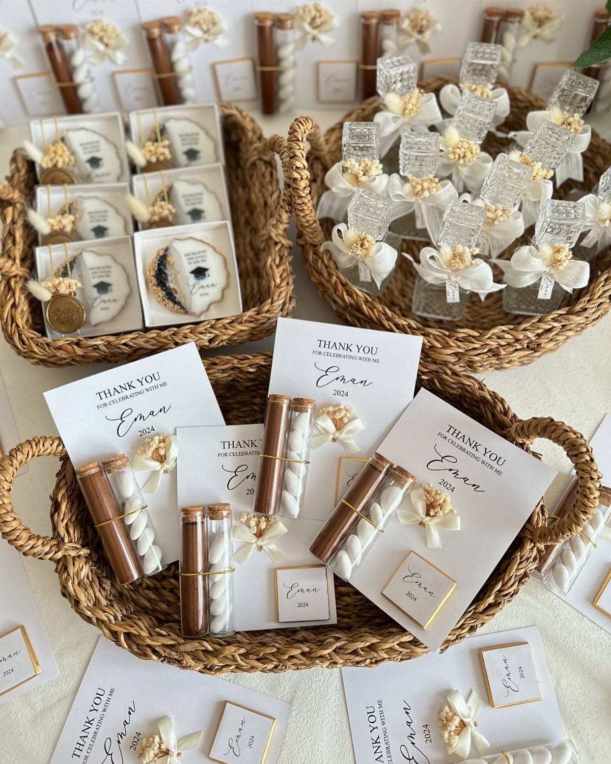 Graduation party favor bags and treats in woven baskets with thank you cards.