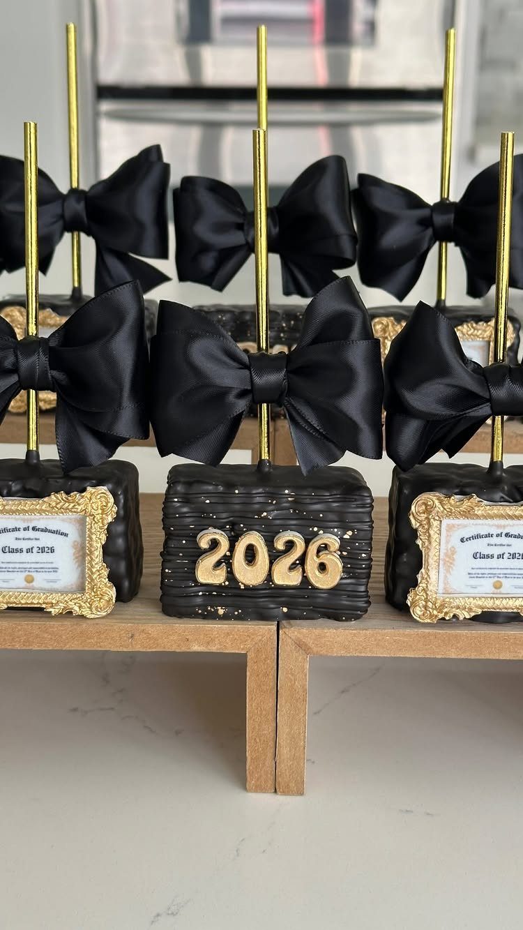 Chocolate cake pops with black bows and gold 2026 graduation decorations.