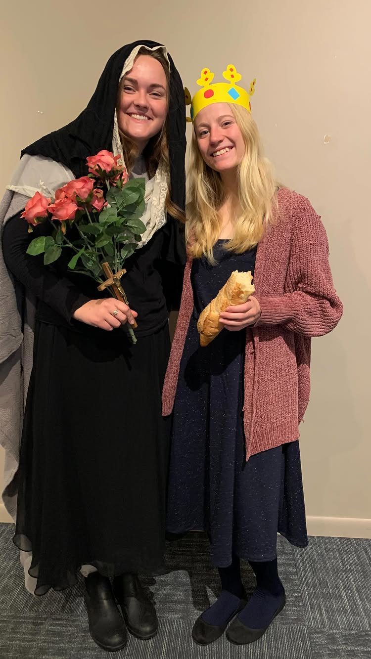 Two women in costumes, one as a nun and one as a queen.