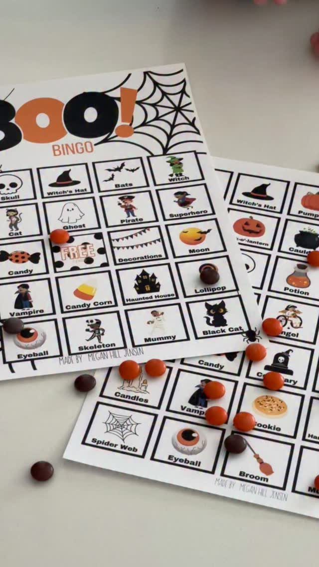 Halloween bingo cards with spooky illustrations and small candies used as game markers.