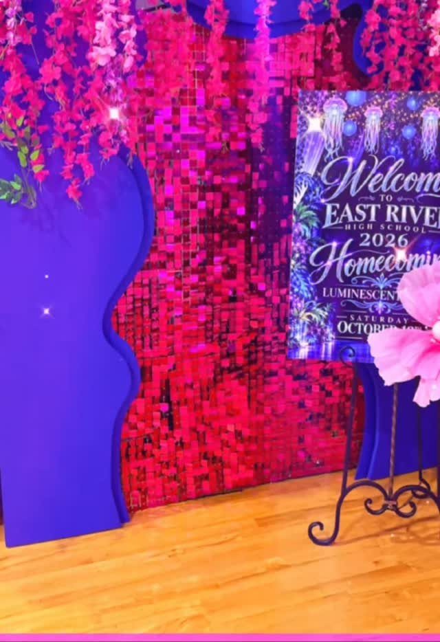 Homecoming event decorations with a pink sequin wall, purple accents, and welcome sign.