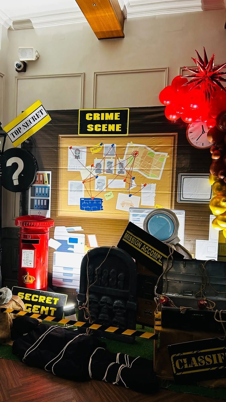 Detective themed party setup with a crime scene board, red post box, and props.