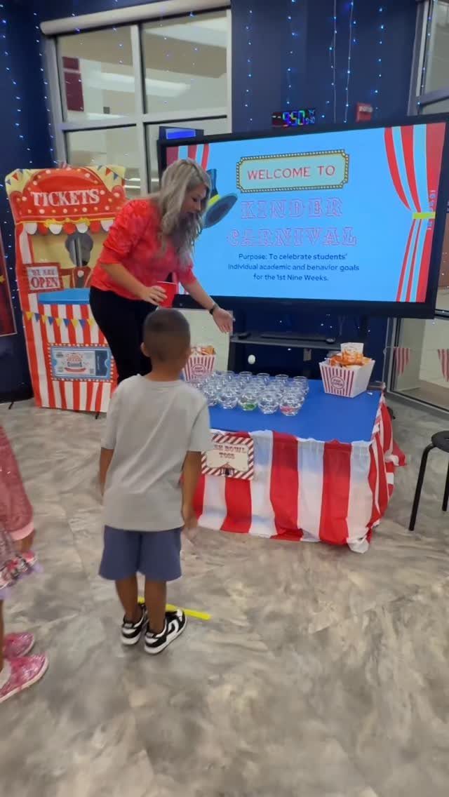 Carnival themed classroom setup with red and white striped table and ticket sign.