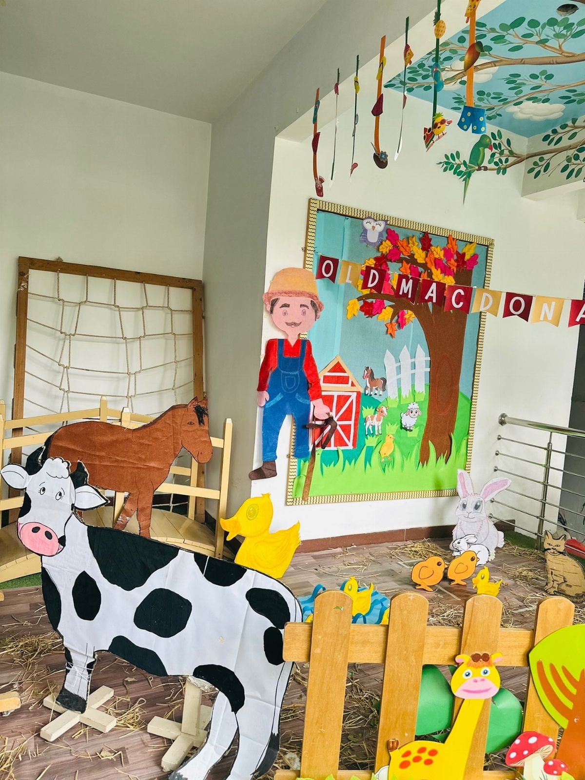 Farm themed classroom display with cardboard cow, horse, and Old MacDonald backdrop.