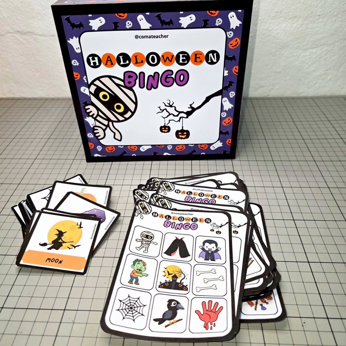 Halloween Bingo game set with themed cards and calling tiles on a grid.
