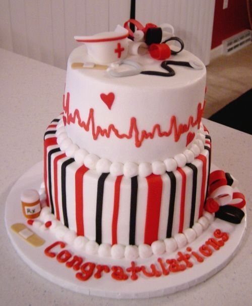 Two-tier white and red nursing graduation cake with stethoscope and nurse's hat topper