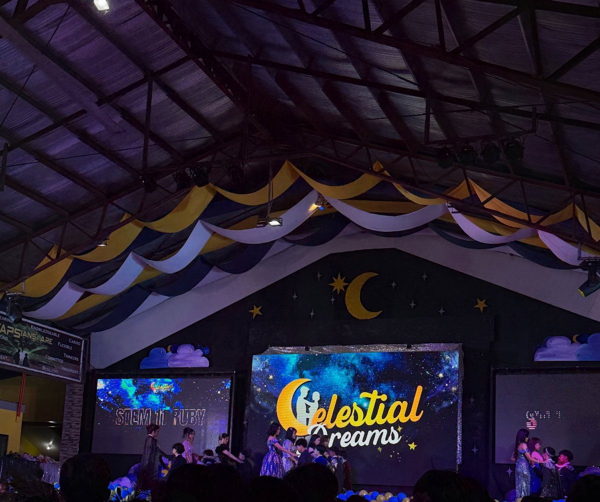 Prom venue with galaxy-themed screen and fabric decorations for Celestial Dreams theme.