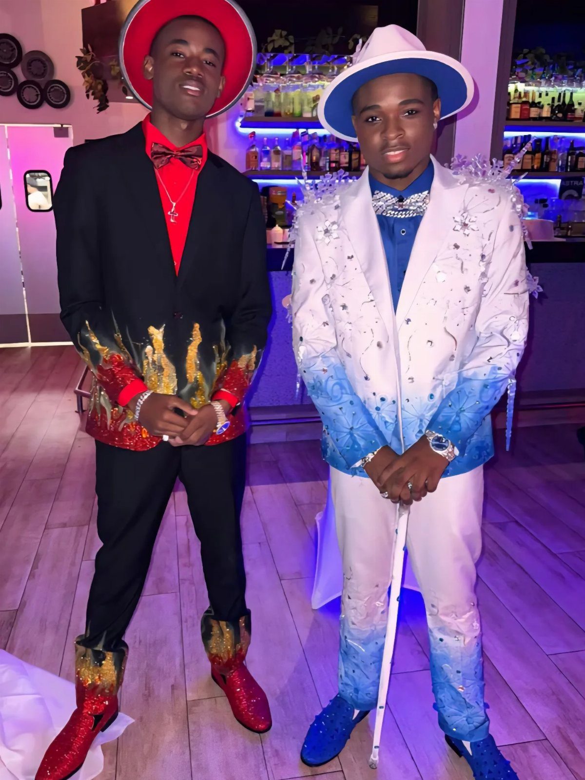 Two men in custom suits featuring contrasting red flame and blue ice designs.