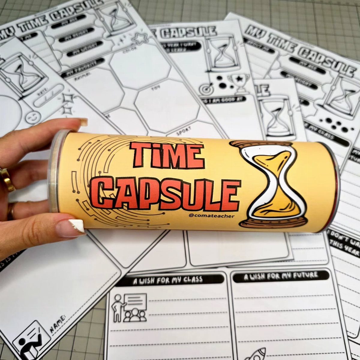 Yellow time capsule container held over printed memory worksheets for students.
