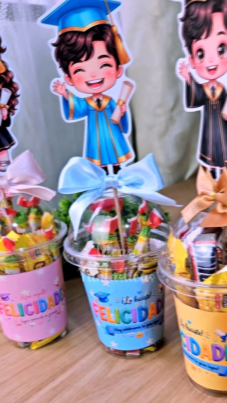 Candy filled cups with graduate cartoon cutouts and ribbons for a graduation celebration.