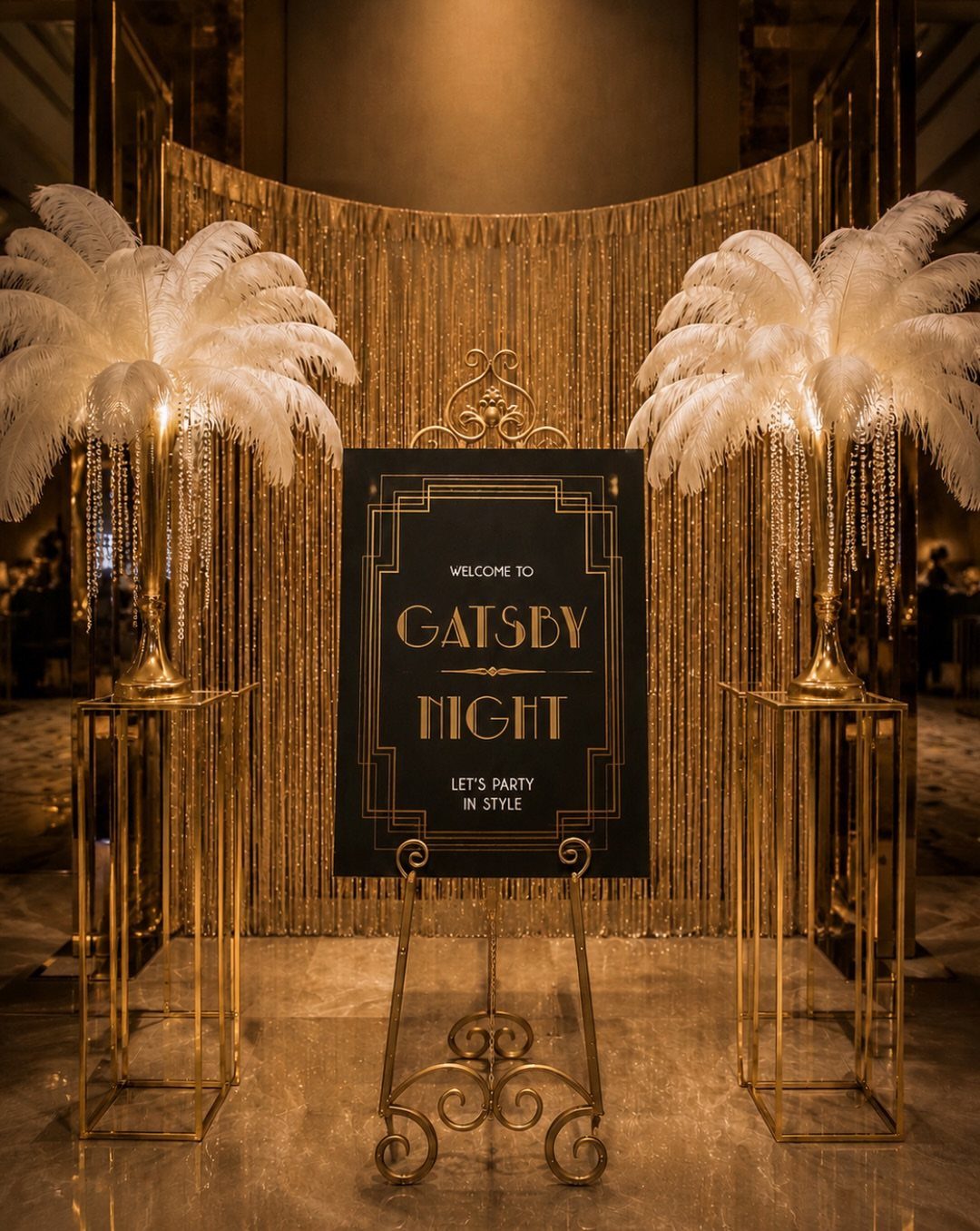 Gatsby Night sign with gold accents, white feathers, and shimmering gold backdrop.