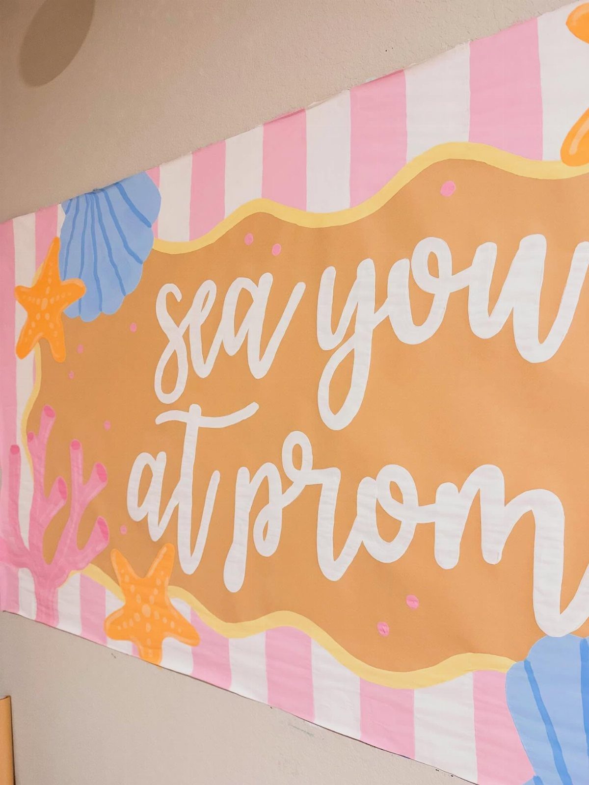 Prom banner with sea theme, pink stripes, and text saying sea you at prom