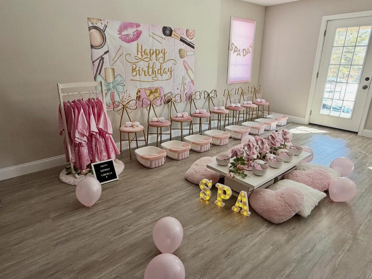 Spa birthday party setup with pink robes, foot basins, and gold SPA letters.