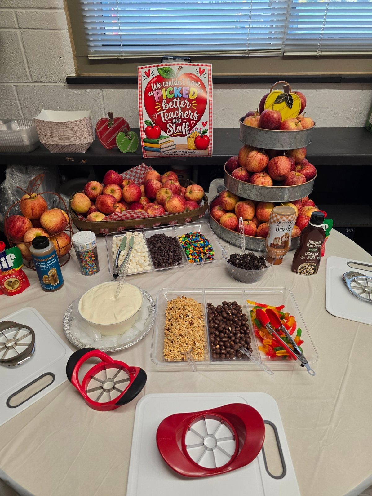 Apple themed breakfast spread with fresh red apples and various sweet dipping toppings.